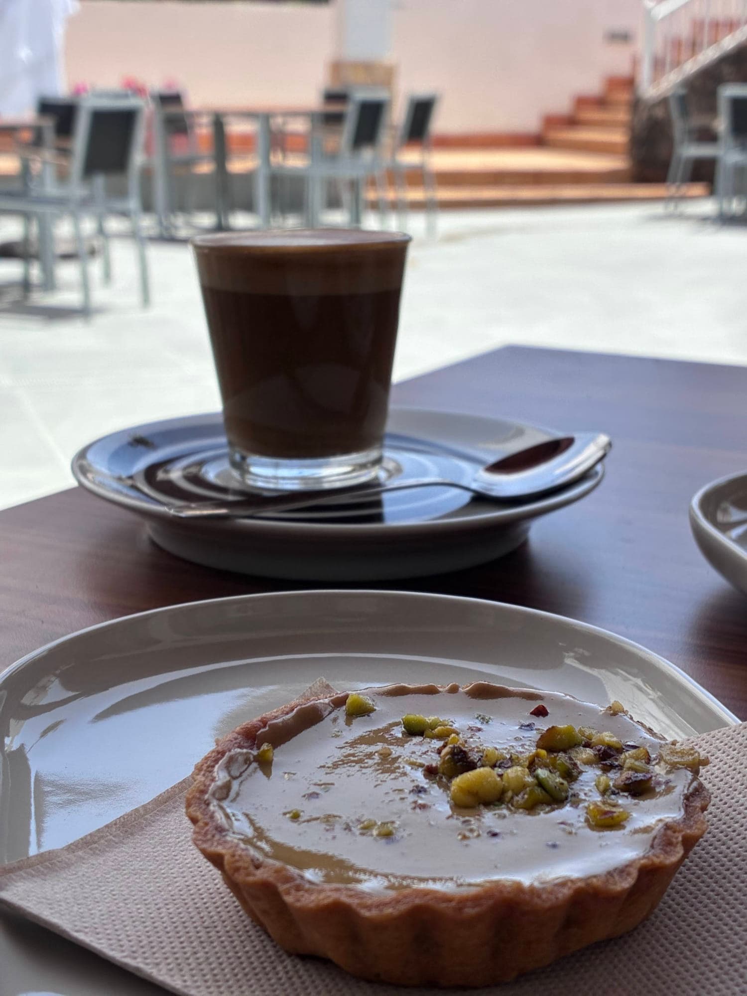 Pistachio tart and coffee at a terrace cafe