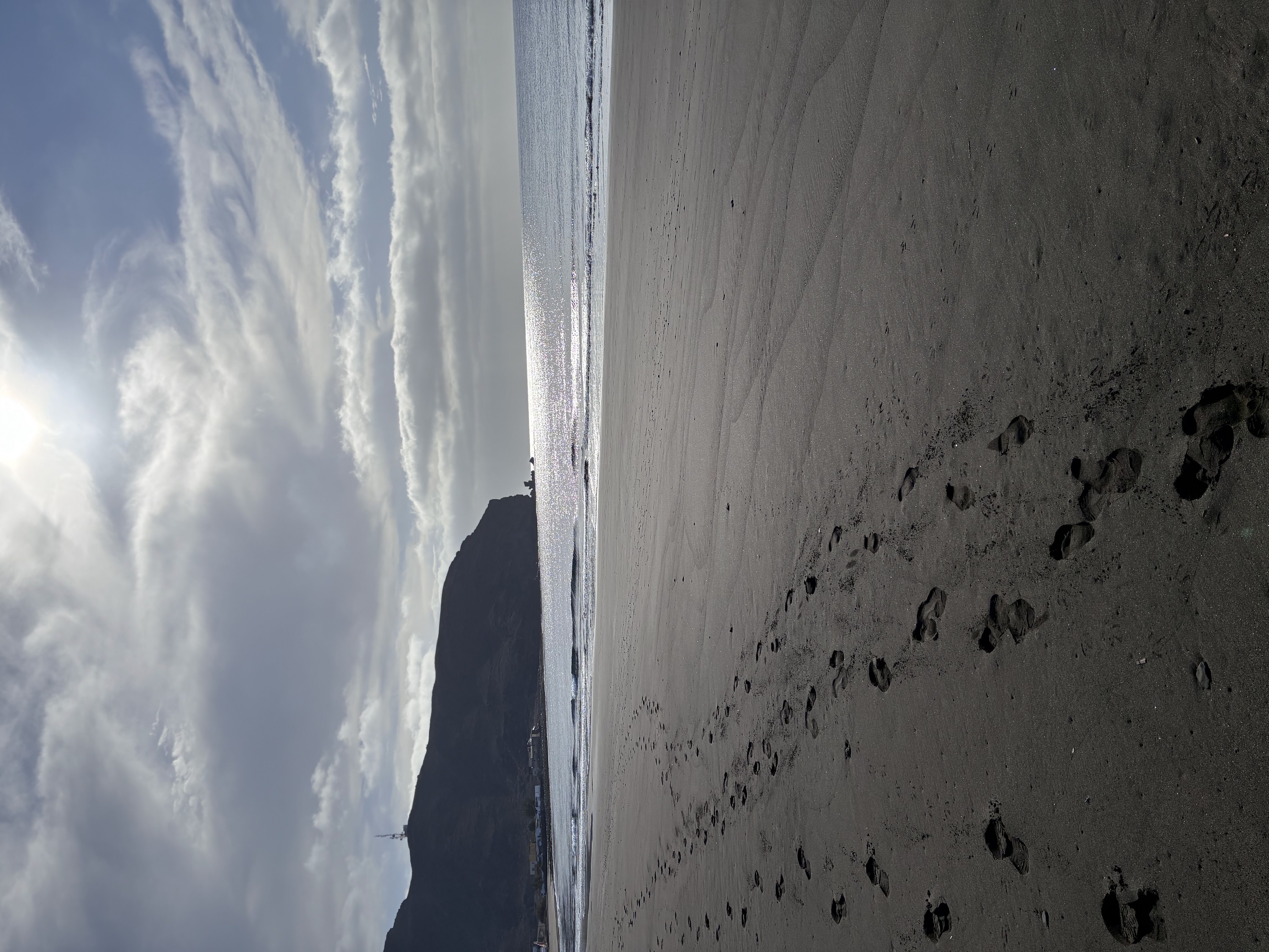 Footprints on the beach at sunset